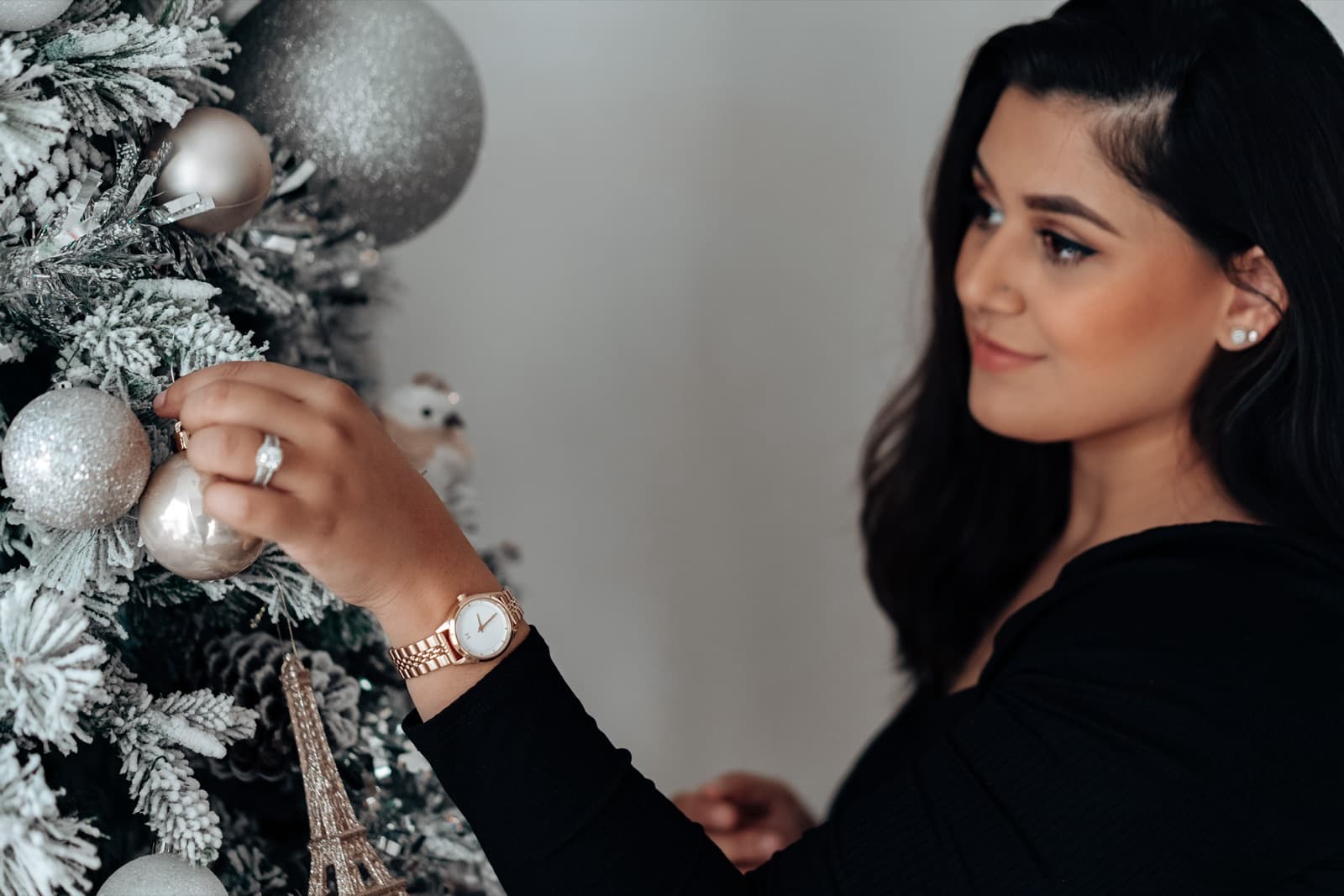 Fatima decorating a flocked Christmas tree