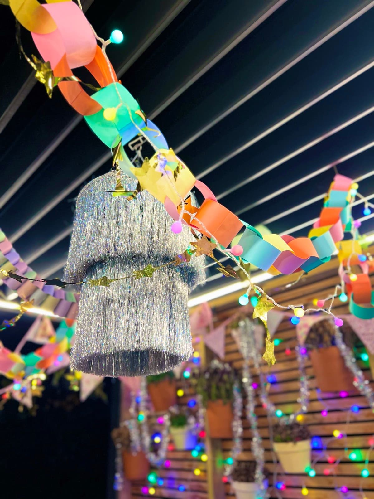 Paper chain garlands and a tinsel chandelier